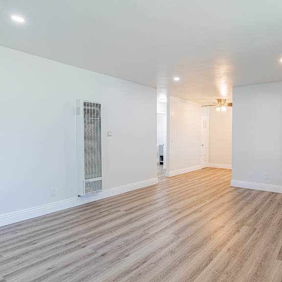 a room with wooden flooring and white walls.