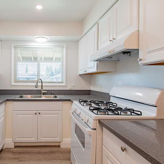 a kitchen with white appliances and cabinets.