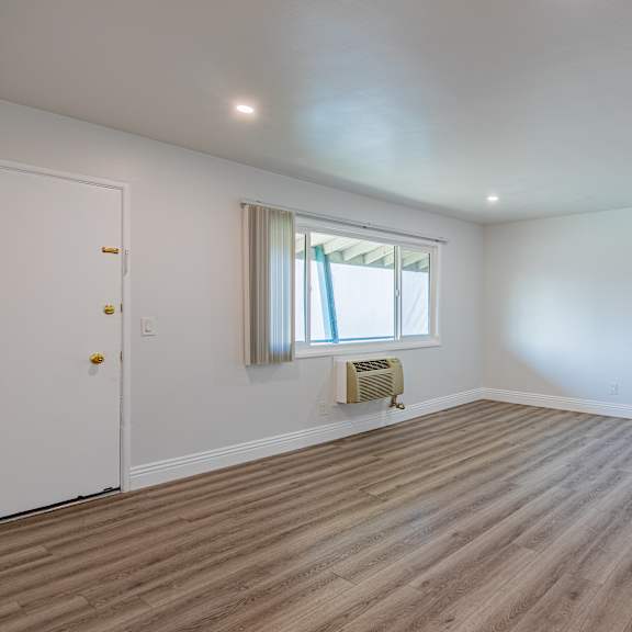 a room with a window and a radiator on the floor.