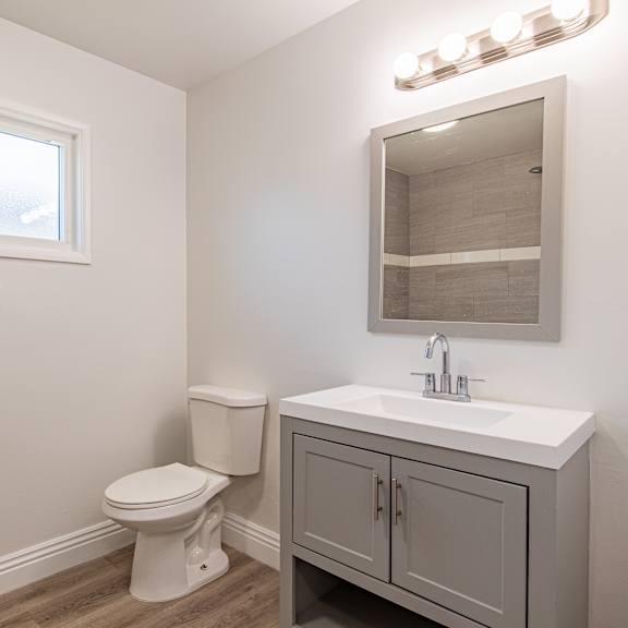 a white toilet sits next to a sink in a small bathroom.