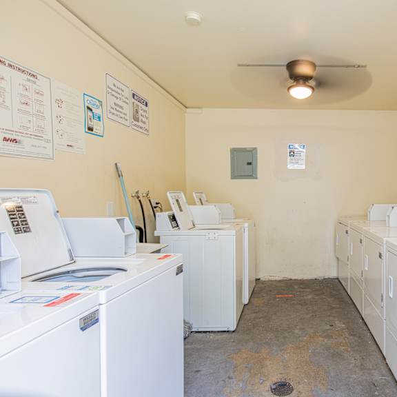 a laundry room with washers and dryers.