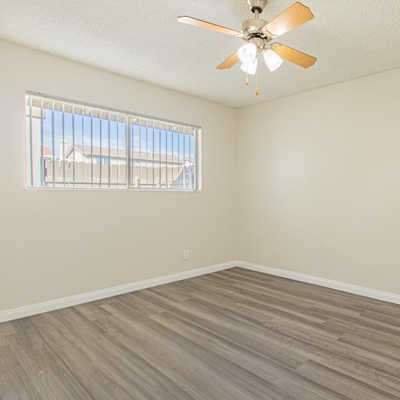 empty room with a ceiling fan and a window.