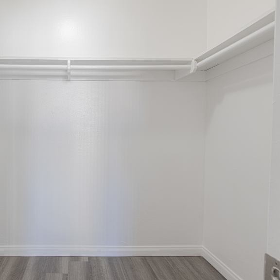 a white room with a wooden floor and white walls.