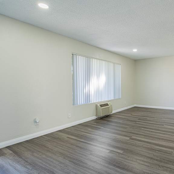 a room with a window and a heater on the floor.
