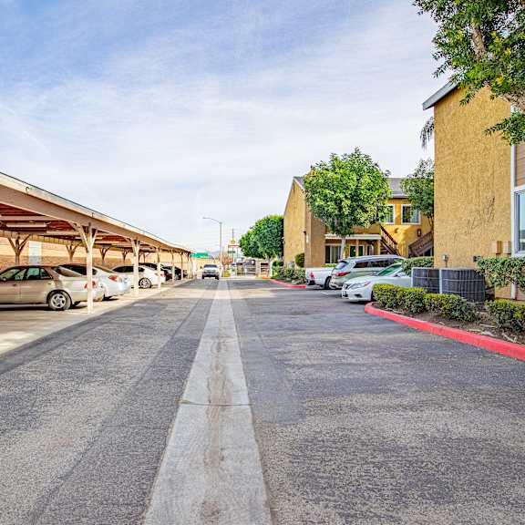 a parking lot with cars parked under a canopy.