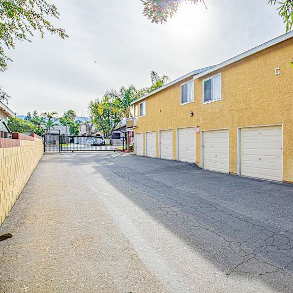 a long yellow building with white garage doors.