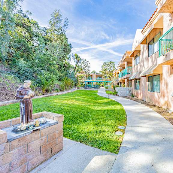 a residential area with a fountain in the foreground.