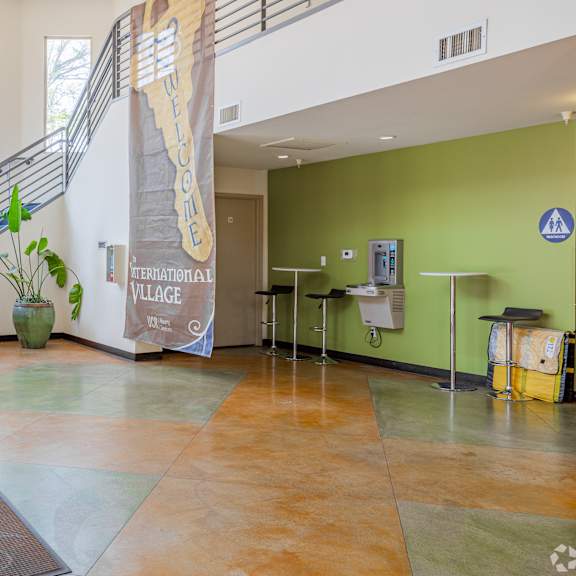 a hallway with a staircase and a green wall.