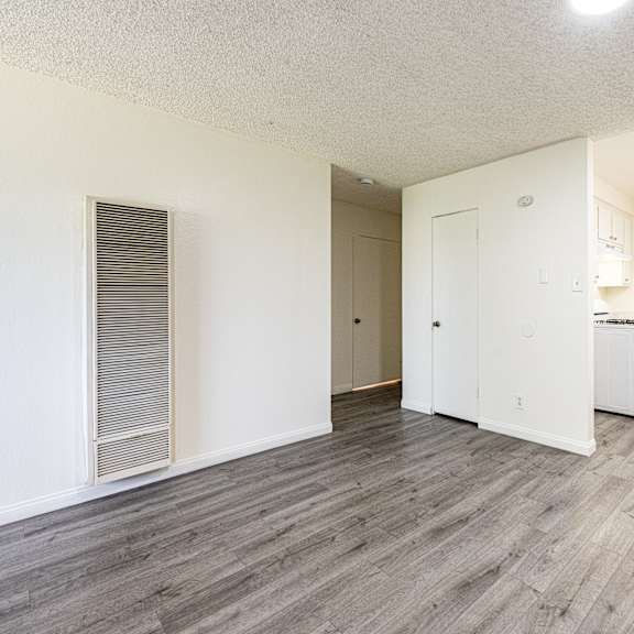 a room with a white fridge and a white cabinet.