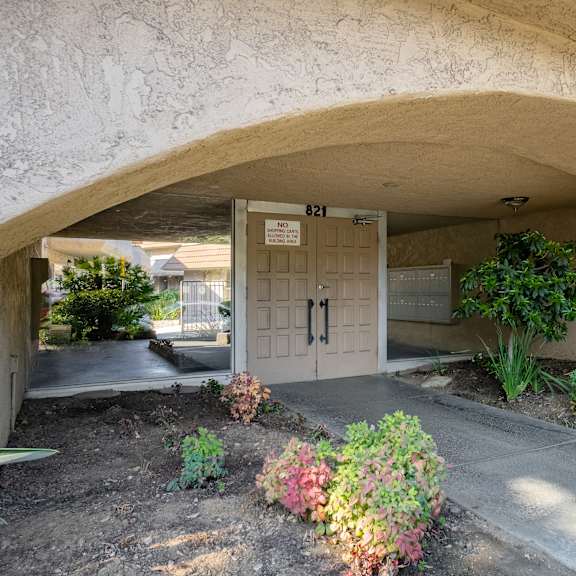 a concrete archway with a door and a sign that says "no parking" on it.