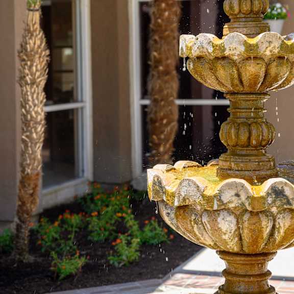a fountain in front of a building at oak terrace senior apts, hemet