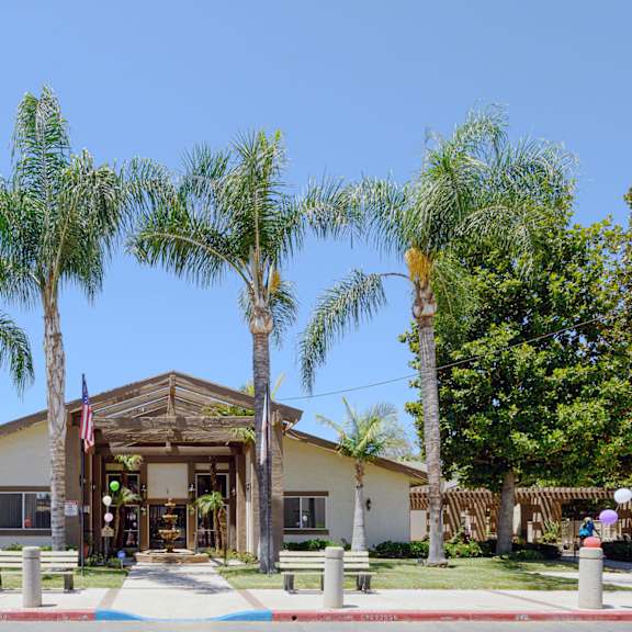 a building with palm trees in front of it at oak terrace senior apts, hemet, ca 92543   