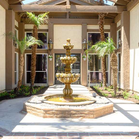 a fountain in front of a building at oak terrace senior apts, hemet, 92543