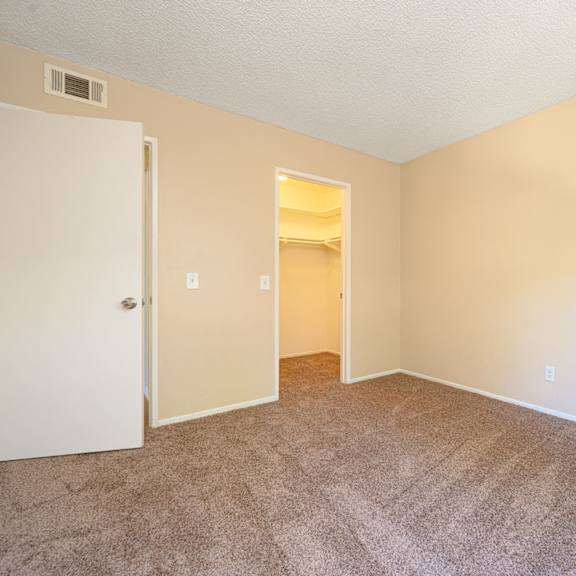 a bedroom with a carpeted floor and an open door at oak terrace senior apts, hemet california