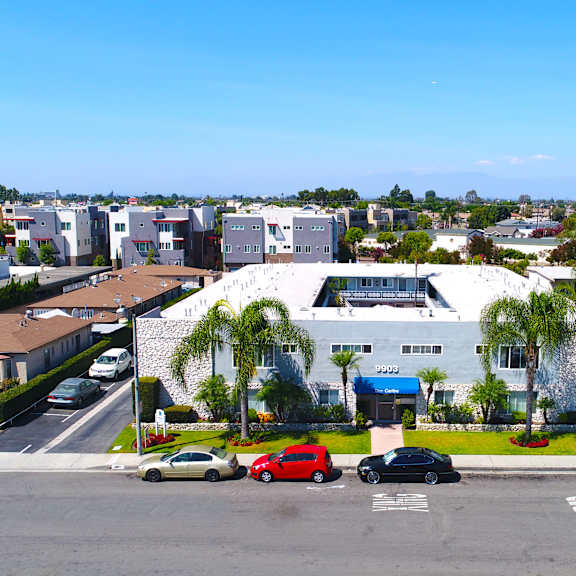 a parking lot with cars and a building in the background.