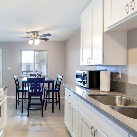 a kitchen with a dining table and chairs.