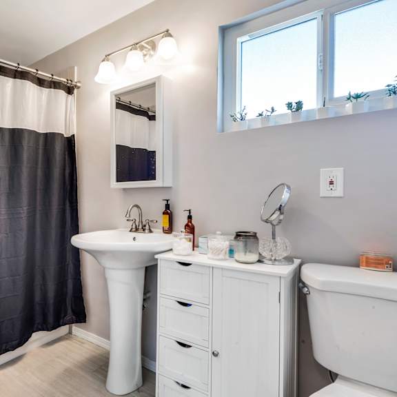 a bathroom with a white sink and a white tub.
