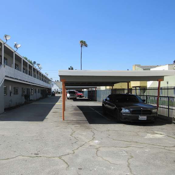 a black car is parked in a parking lot.