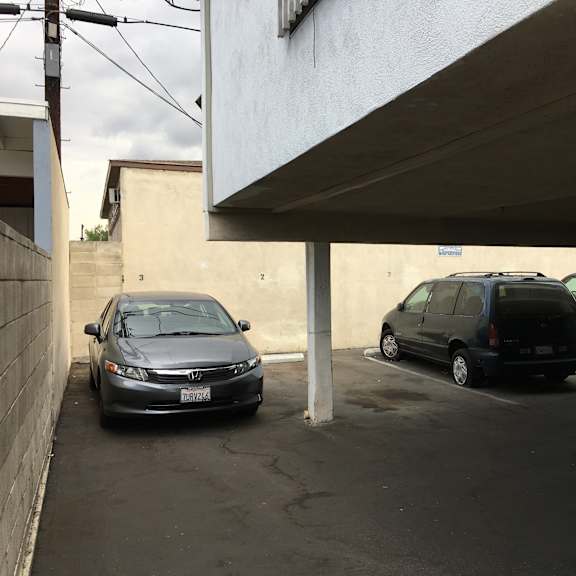a black honda civic is parked in a parking lot.