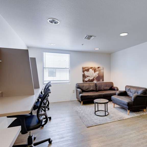 our apartments offer a living room with a couch and a coffee table at helix at university village, pomona