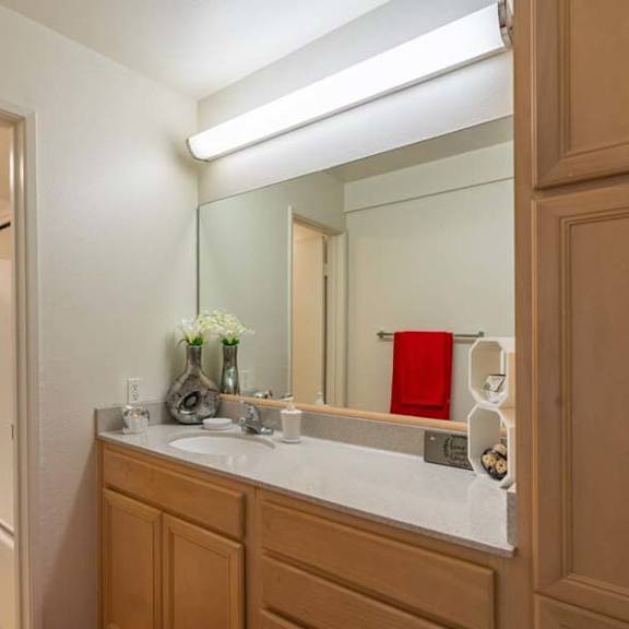 a bathroom with a toilet a sink and a mirror at mountainview venture, covina california