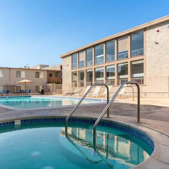 a resort style pool and hot tub with a building in the background at mountainview venture, california