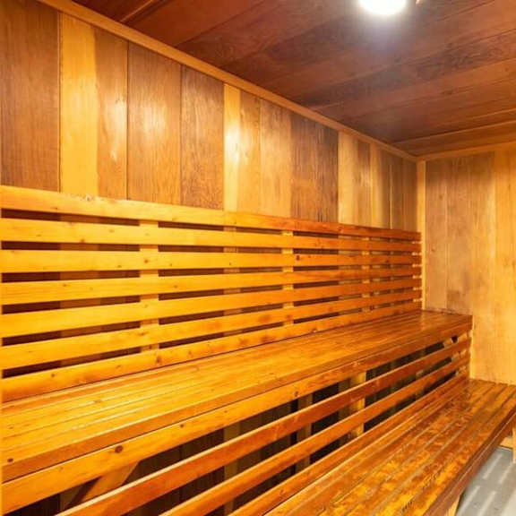 a sauna with a wooden bench and a trash can at mountainview venture, covina california