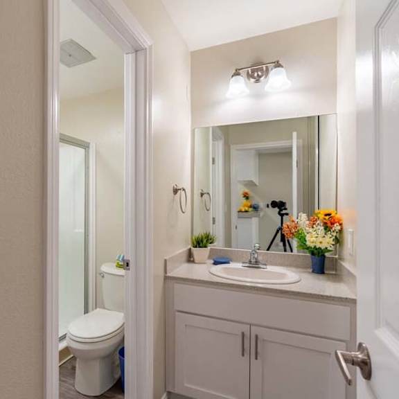 a bathroom with a toilet sink and mirror at mountainview venture, covina california