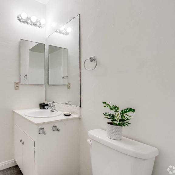 a bathroom with a sink and a mirror and a toilet at university park, azusa, 91702