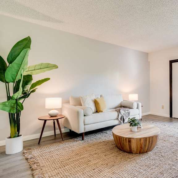 a living room with a couch and a coffee table and a sliding glass door at university park, california, 91702