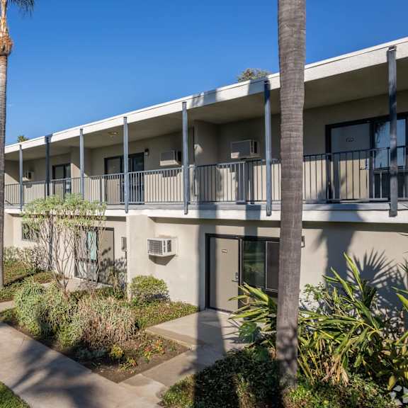 the courtyard of a condo building with palm trees at university park, california