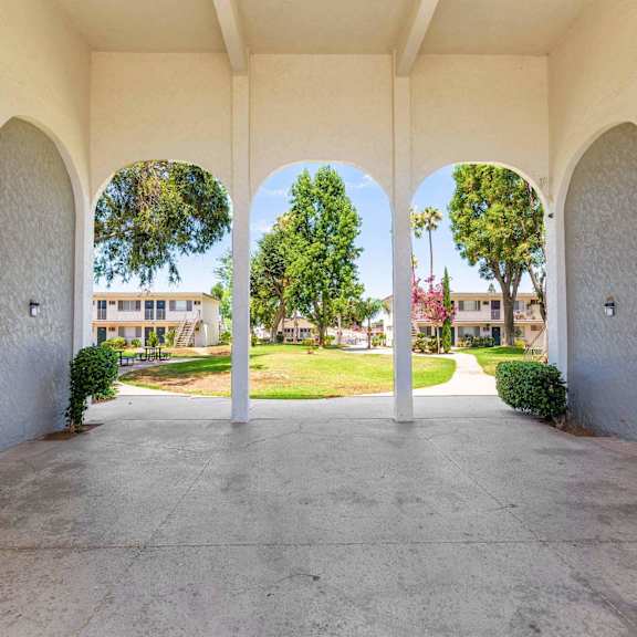 the archway of a building with a view of the grass at sunnymead apts apartments, moreno valley, ca, 92553