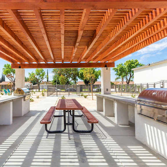 a patio with a picnic table and a grill at sunnymead apts apartments, moreno valley, 92553