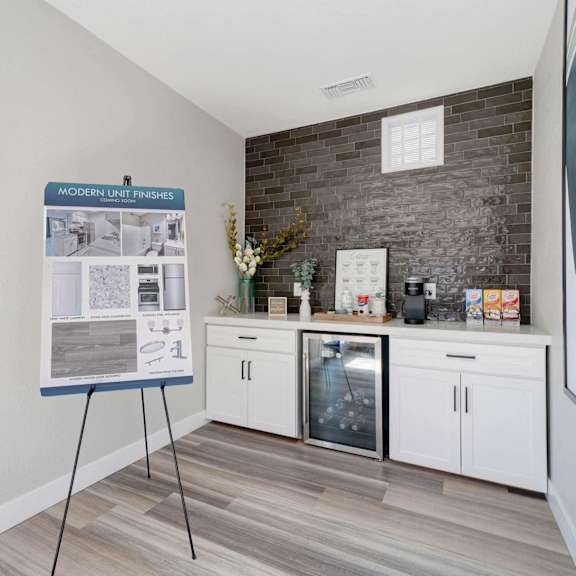 the preserve at ballantyne commons community room with counter and refrigerator and bulletin board at sunnymead apts apartments, moreno valley