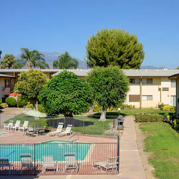 a view of the courtyard and pool at the whispering winds apartments in pearland, tx at park columbia apts, hemet, ca