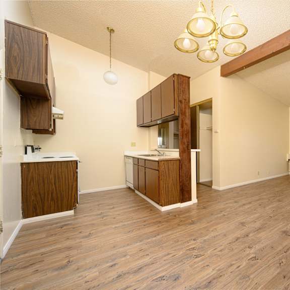 a kitchen and living room in a 555 waverly unit at park columbia apts, hemet, ca