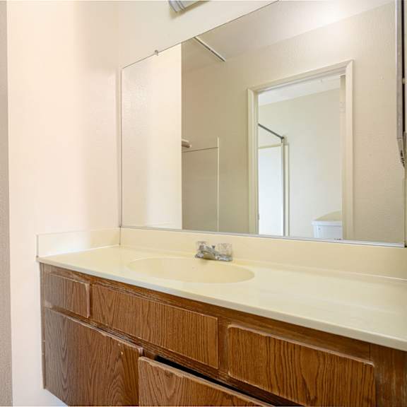 a bathroom with a sink and a mirror at park columbia apts, hemet