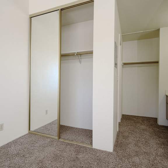 a bedroom with white walls and a carpeted floor at park columbia apts, california