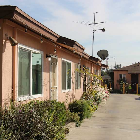 a long building with a satellite dish on top.