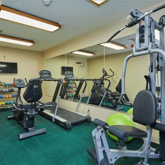 a gym with weights and other exercise equipment in a home gym at huntington terrace north senior, huntington beach, ca 92648