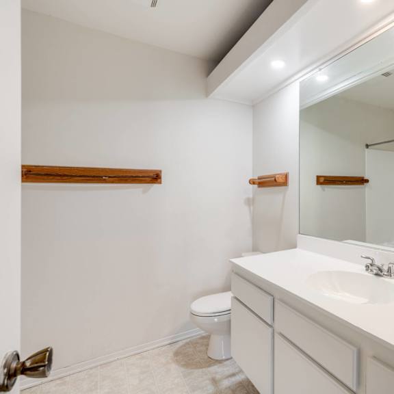 a bathroom with a large mirror and a sink and a toilet at alosta place, azusa, 91702