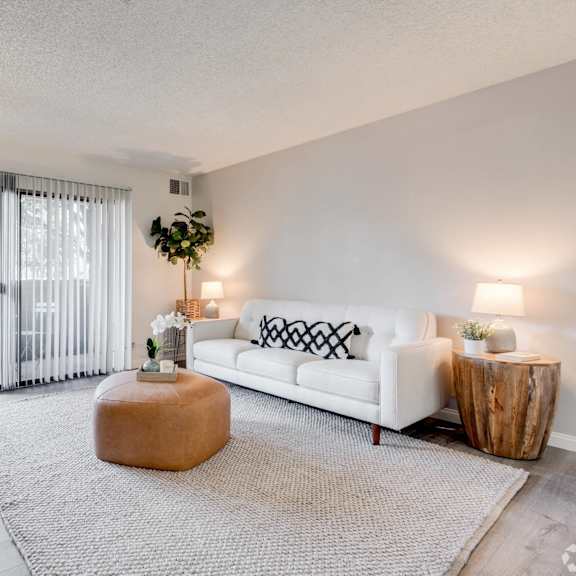 a living room with a couch and a coffee table and a sliding glass door at alosta place, california, 91702
