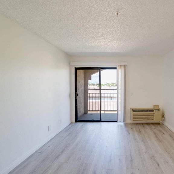 the preserve at ballantyne commons apartment living room with wood flooring and balcony at flamingo garden senior apts, el monte