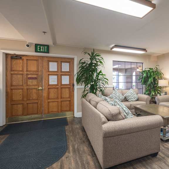 a living room with couches and chairs and a table at huntington terrace north senior, huntington beach