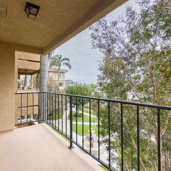 the balcony has a view of the backyard and the trees at huntington terrace north senior, california