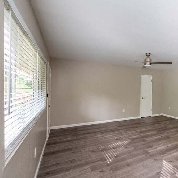 an empty living room with a ceiling fan and a window at north view terrace, california