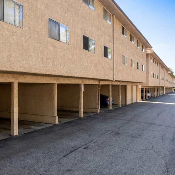 an empty parking lot in front of a brick building at north view terrace, california, 90640