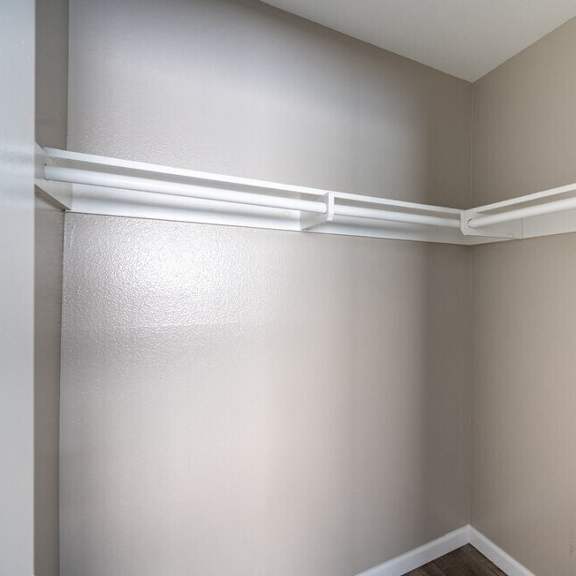 the corner of a room with white shelves on the wall at north view terrace, montebello, 90640