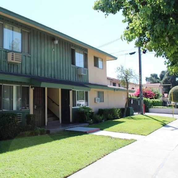 a building with a green awning and a white sign on the wall.