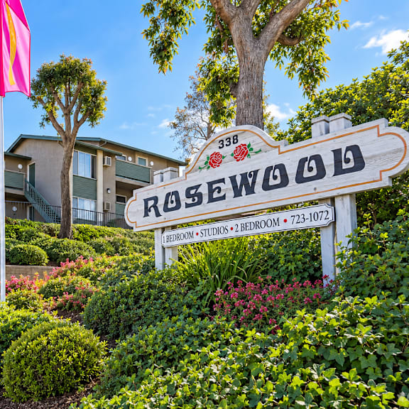 a sign for rosewood in front of a building.